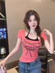 148037Retro spicy girl fun strap printed short sleeved T-shirt for women with irregular chest cushion, fake two pieces hanging on the neck